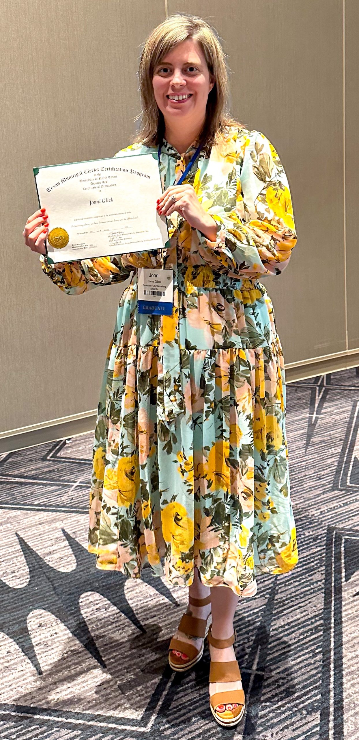 Image of Assistant City Secretary Jonni Glick holding a certificate of completion