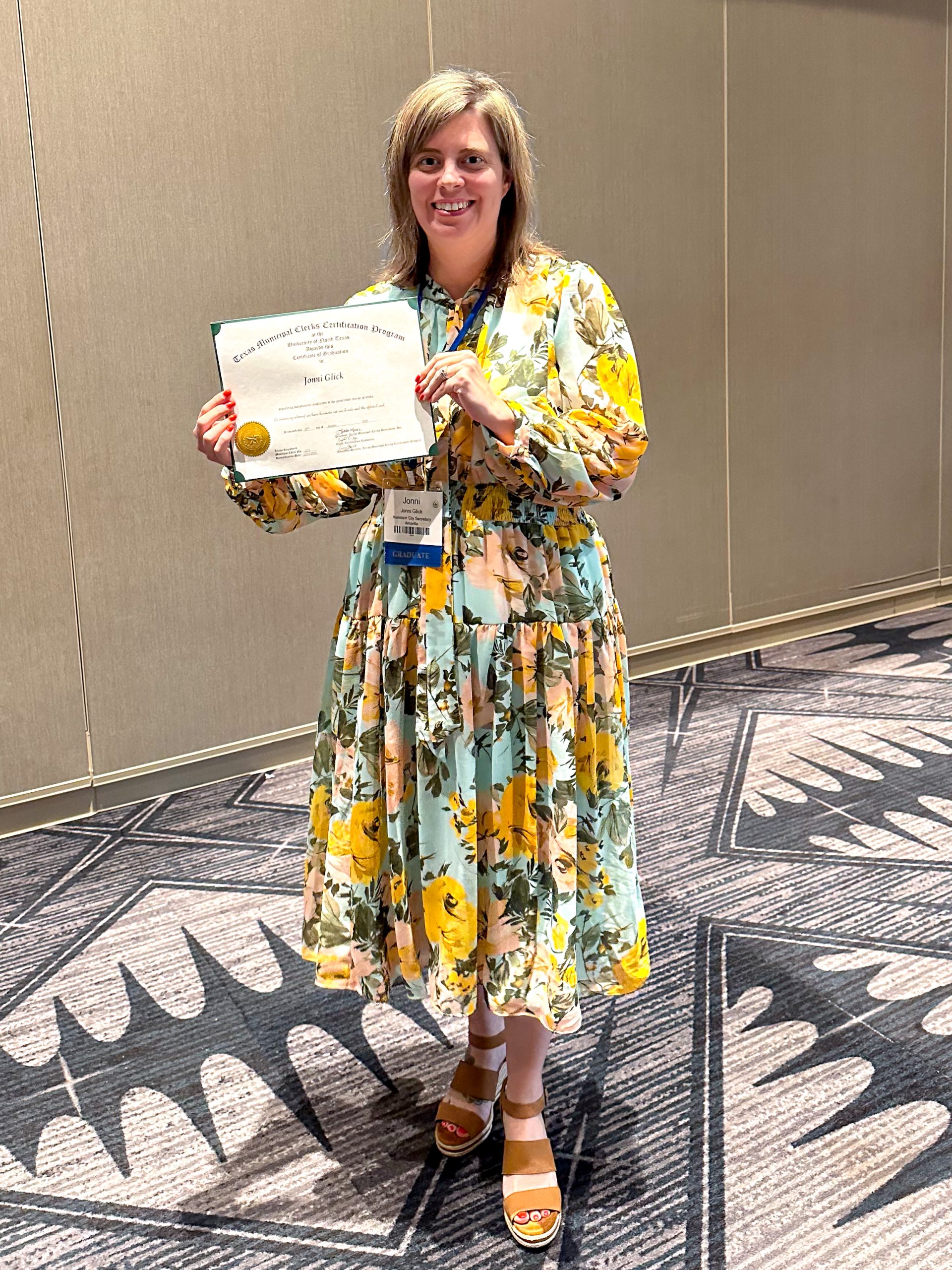 Image of Assistant City Secretary Jonni Glick holding a certificate of completion