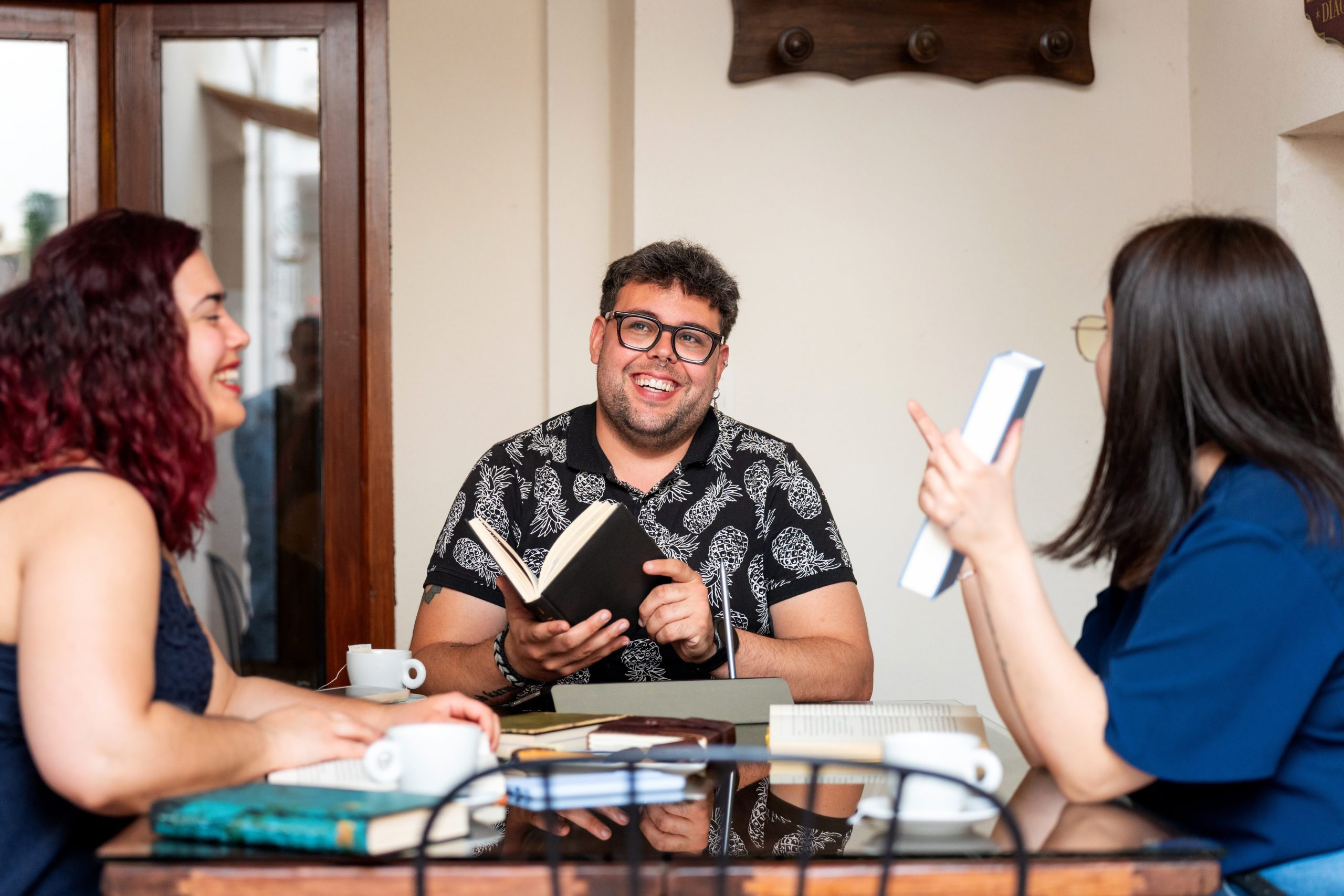 A group of young adults discussing a book