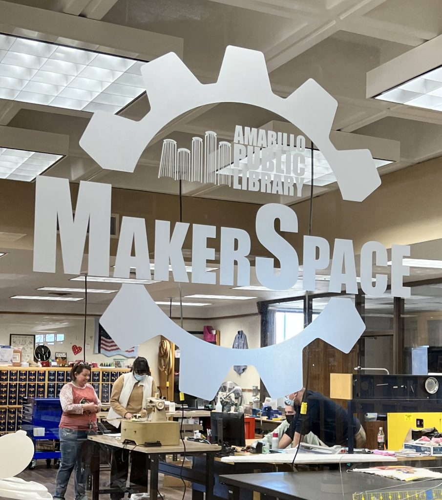 A look into the MakerSpace window with a few people working on various crafts