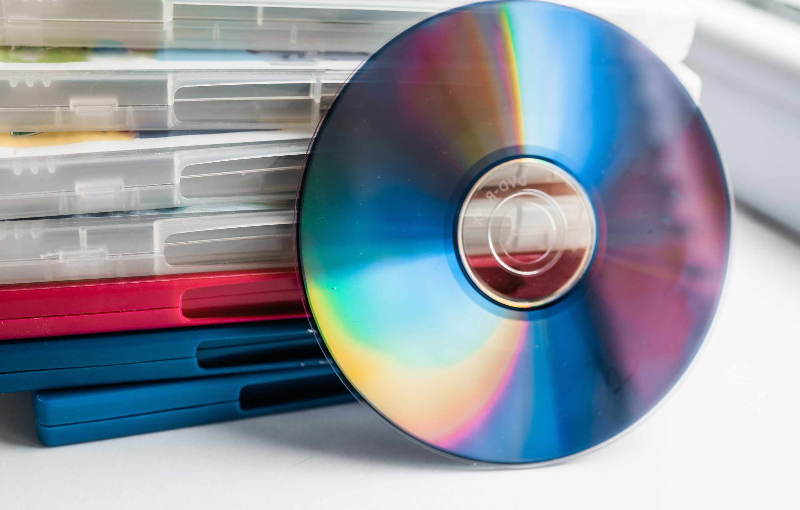A DVD resting against a stack of DVD cases