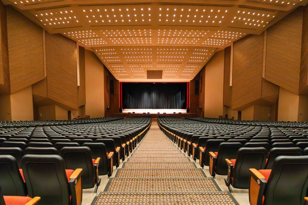 The inside of the Civic Center's Auditorium showcasing endless rows of seats leading to a main stage