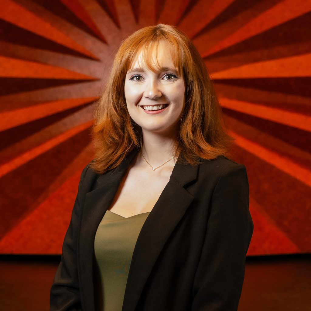 Headshot of Civic Center's Event Supervisor Tuesday Poling wearing a black blazer and olive green shirt