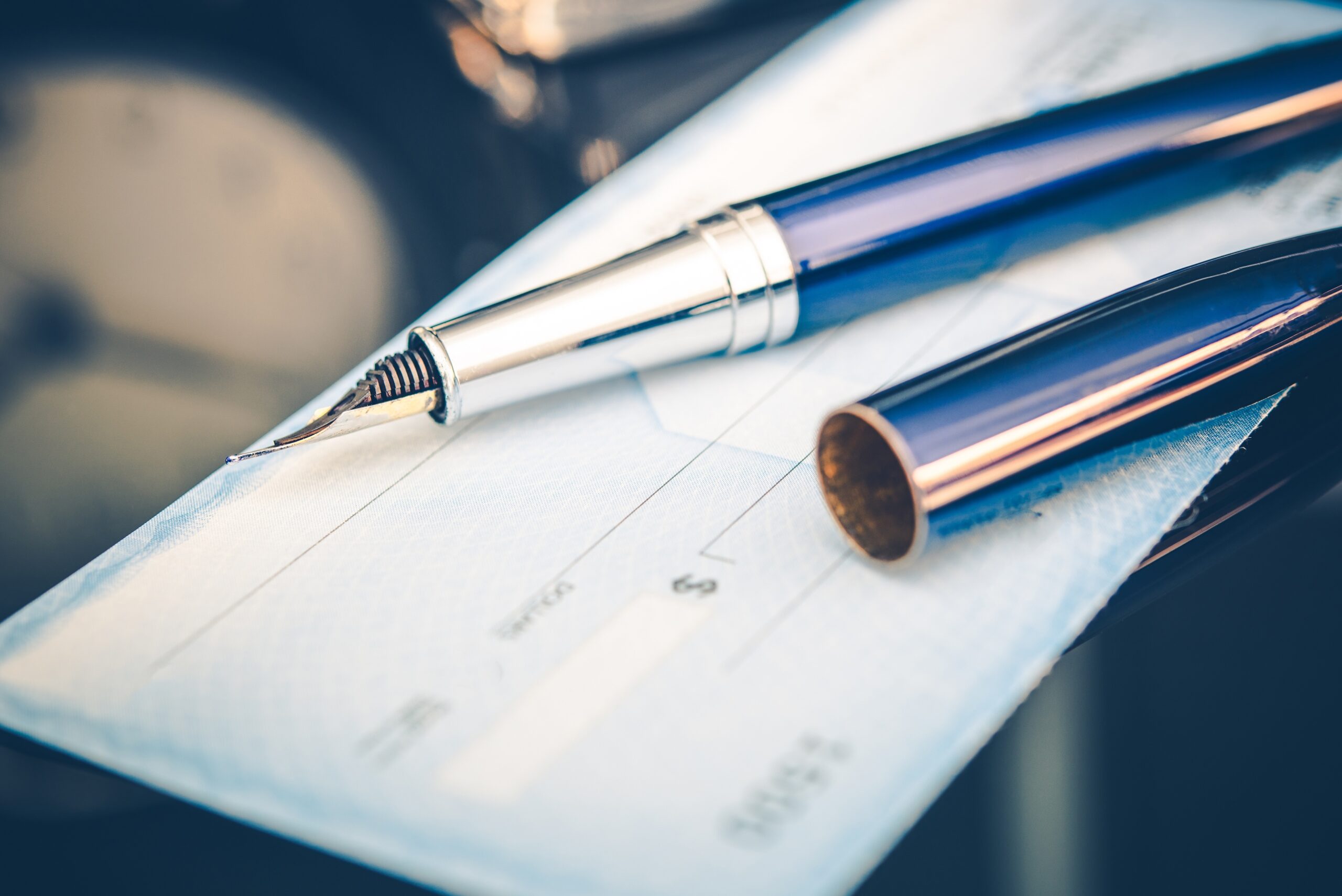 A blank check and pen