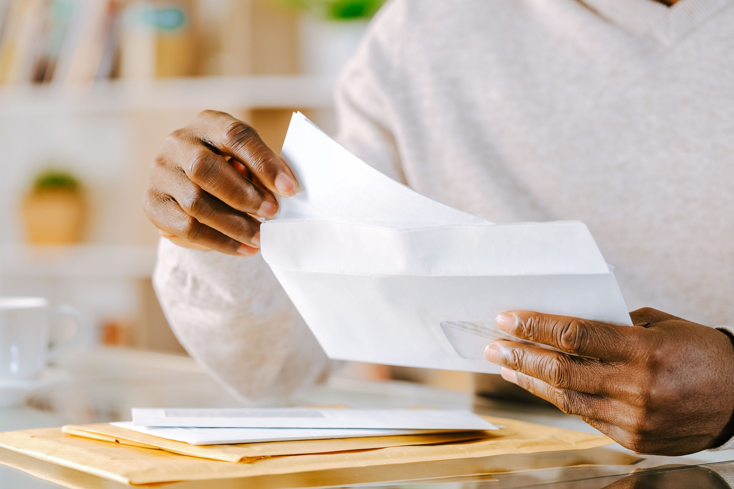 A man putting a letter into an envelope