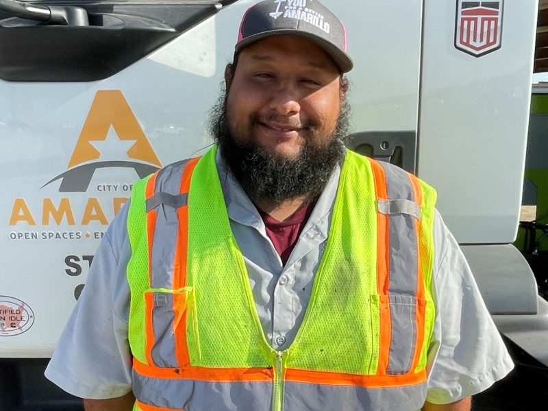 Emilio Aguilera, Street Department Equipment Operator, standing in front of a DuraPatcher truck.