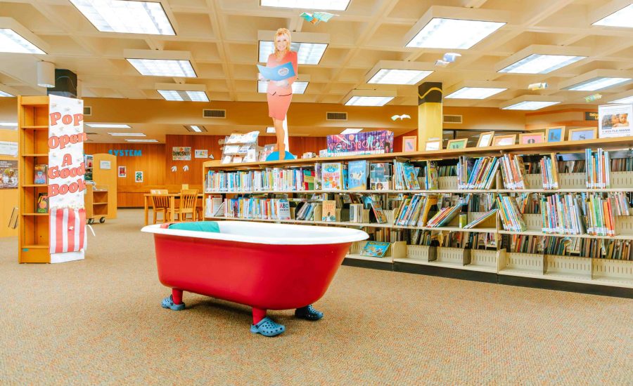 Another view of the Downtown Library's youth section featuring a red clawfoot bathtub that patrons can read in
