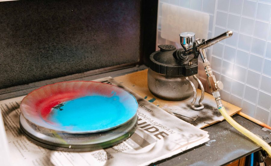 An airbrush station with a plate covered in paint