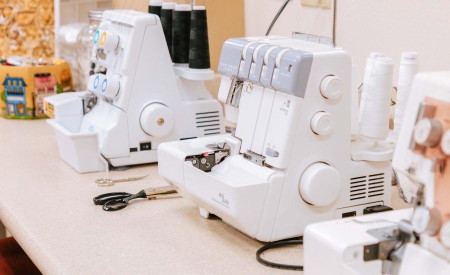 Two serger machines on a desk