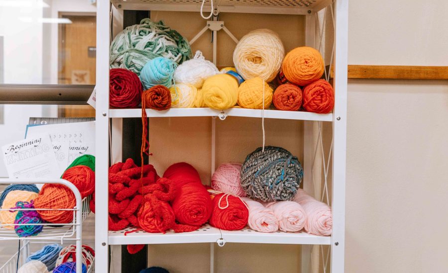 A shelf of yarn in differing colors