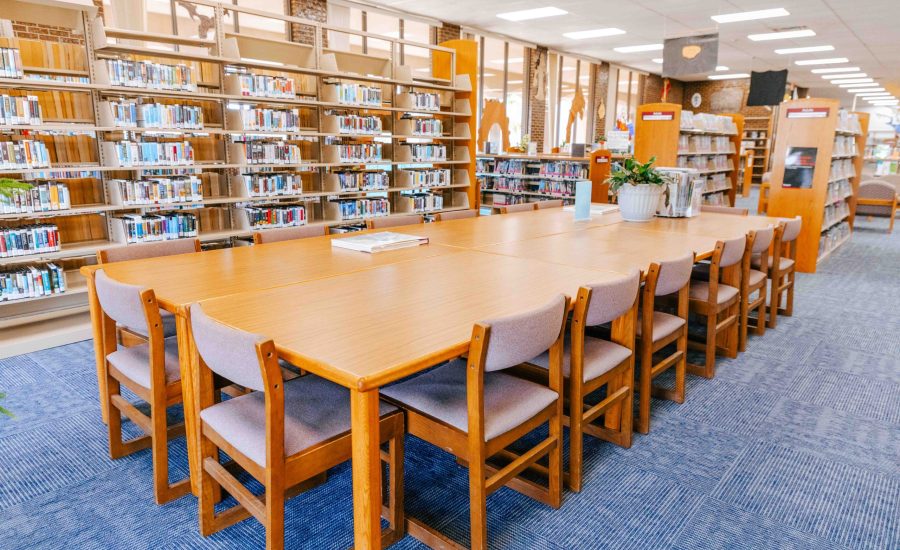 A large group of tables pushed together with chairs on every side