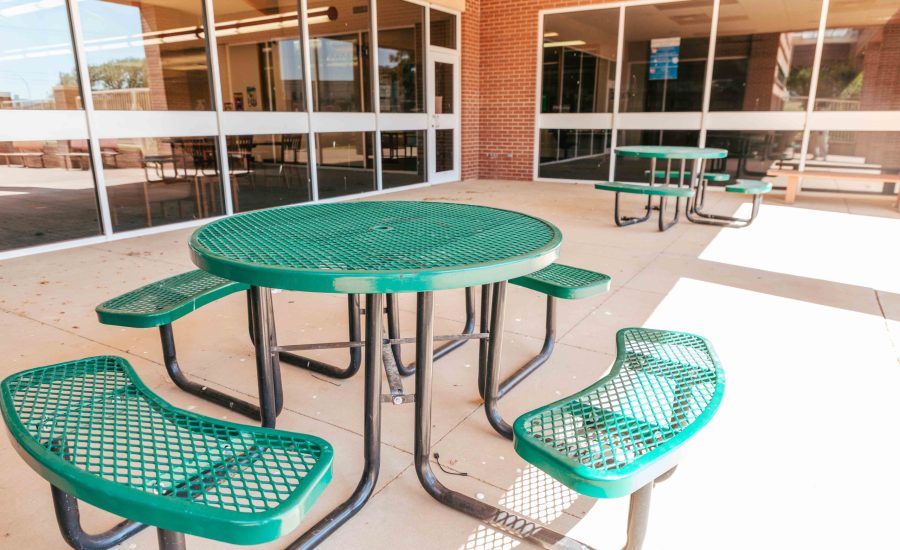 The Northwest Branch's outdoor patio with two green picnic tables
