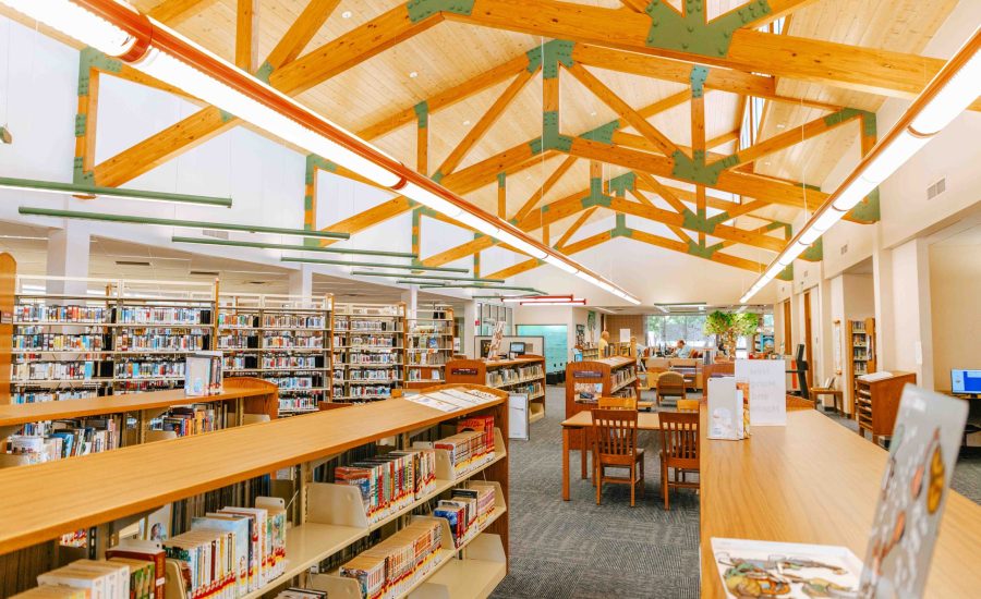 A look inside the Northwest Branch library with grand wood beams and rows of bookshelves