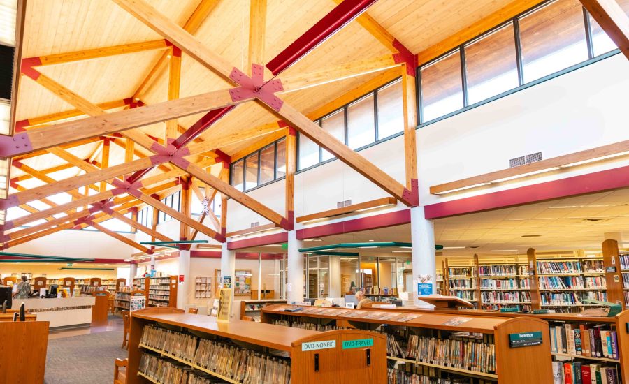The inside of Amarillo Public Library Southwest Branch featuring grand wooden beams and rows of bookshelves