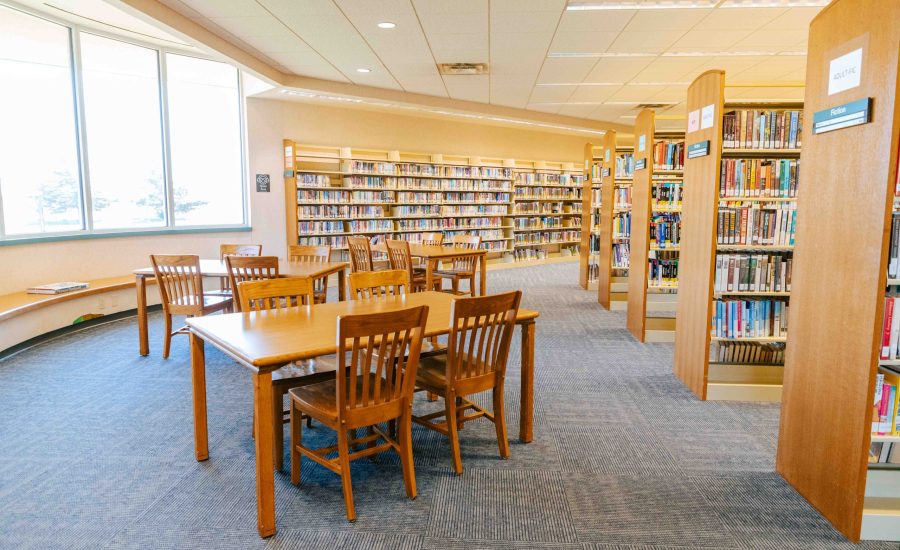 Community study areas at the Southwest Branch featuring three sets of rectangular tables with four chairs each